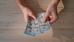 Cómo se calcula la prima vacacional según la ley laboral en México 11 manos contando dinero sobre mesa wooden