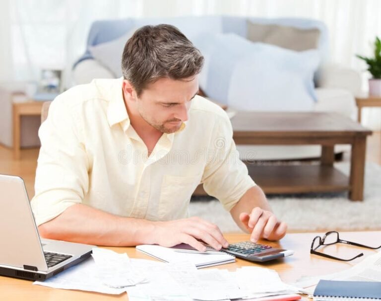 persona calculando finanzas con calculadora y tabla